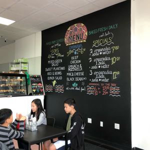 Big, colorful menu on the wall at Jessy's Pastries in Westbury