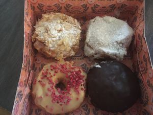 4 donut box: Caramel Almond Coconut; Bienenstich; Apricot Raspberry; Boston Cream at Brammibal's Donuts - Potsdamer Platz in Berlin