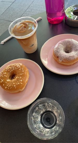 Lemon poppyseed doughnut, caramel hazelnut doughnut, oat milk latte  at Brammibal's Donuts - Potsdamer Platz in Berlin