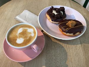 Vanilla cream + Peanut butter donuts, and cappuccino at Brammibal's Donuts - Potsdamer Platz in Berlin