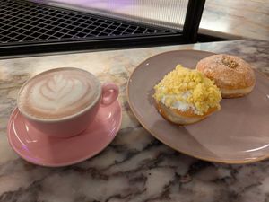 Mimosa doughnut (left, 3⭐) and chocolate hazelnut bomboloni (right, 5⭐). Plus a hot chocolate. at Brammibal's Donuts - Potsdamer Platz in Berlin