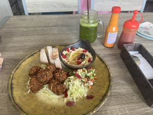 Green moringa tea and falafel plate with two salads and hummus   at Twenty4 in Siquijor