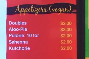 Labeled vegan appetizer selection at Singh's Roti Delight in Lauderdale Lakes