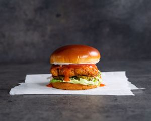 The Freebird - Crispy chickin’, buffalo sauce, pickles, lettuce, tomato, and ranch on a brioche bun at Stand-Up Burgers in Berkeley
