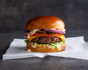 The O.G. - Grilled Impossible patty made with Miyoko’s Creamery cheddar, lettuce, tomato, red onion, pickles, and special sauce on a brioche bun at Stand-Up Burgers in Berkeley