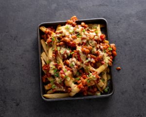 Chili Cheese Fries - Crispy golden fries topped with chili, spicy queso sauce, and green onions at Stand-Up Burgers in Berkeley