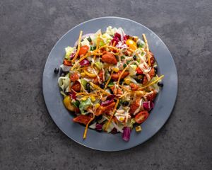 Flip The Bird - Crispy chickin’ tossed in BBQ sauce over mixed greens, tomato, roasted corn, black beans, red onion, tortilla strips, and creamy chipotle dressing at Stand-Up Burgers in Berkeley