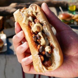 Kick off summer with our new Chili Dog! This 100% plant-based treat features a Field Roast Hot Dog™ smothered in house-made chili, with dijon mustard served in a poppyseed bun. at Stand-Up Burgers in Berkeley