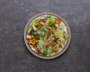 Introducing our version of the Classic Chickin' Caesar Salad- plant-based crispy chickin' over romaine hearts with our signature caesar dressing, croutons, parmesan, and lemon. at Stand-Up Burgers in Berkeley