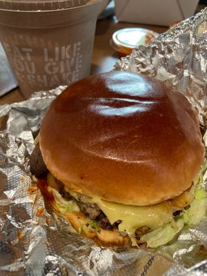 BBQ bacon burger with chocolate milkshake (regular size) in the background at Stand-Up Burgers in Berkeley