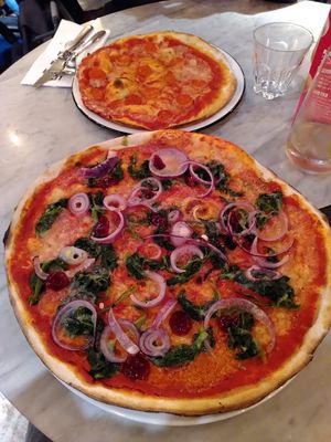 Special pizza with cranberry dressing (front) and delicious 'prosciutto' - quite salty, as it should be (back) at Pizza Express - Aldwych in London