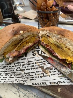 On a fresh grilled bun, grilled pineapple, tomato, chickpea and veg homemade pattie with homemade relish and vegan mayo, spinach and tomato! I’ll be back for another!!   at Farmer & Sun in Gympie