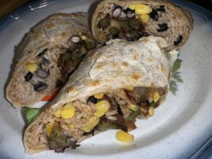 Veganized a quesadilla- ask for a rice and bean quesadilla with no cheese no sour cream. Add guac and peppers, corn, onions. Comes with sour cream too  at The International Delight Cafe in Bellmore