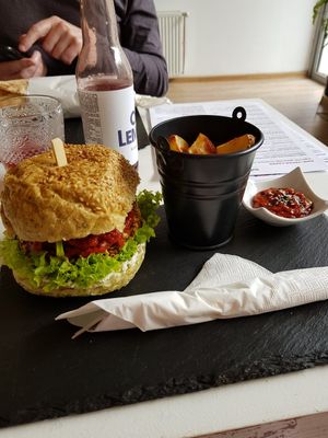 BBQ vegan burger with potato wedges and tomato sauce at Sublimmme in Bucharest