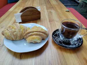 Mock cheese croissants and coffee. at Alma Natura in Medellin