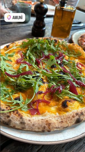 Pumpkin base, marinated onions, greens, olive oil  at Amuni in Bruges