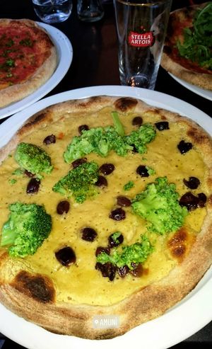 vegan pizza with chickpea cream, broccoli and olives at Amuni in Bruges