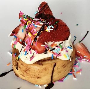 Cake Batter Frosting, Fresh Strawberries, Chocolate Sauce & Rainbow Sprinkles!  at Cinnaholic in Winnipeg