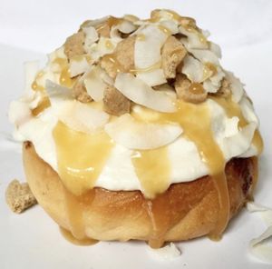 Vanilla Frosting with Cookie Pieces, Coconut & Caramel Sauce! at Cinnaholic in Winnipeg
