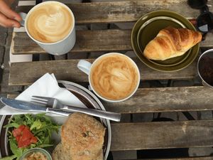 Home baked (lovely) bread with hummus, a croissant, vegan and non-vegan coffee at Petról in Copenhagen