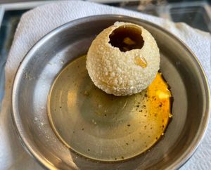 Pani Puri: Hollow fried dough balls filled with black chickpeas, potatoes, and spicy water at 55 Bombay Street in Rotterdam
