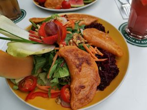 Large vegan salad with four fried pierogies (filled with dried tomatoes, spring onions, zucchini) at Malinas in Dusseldorf