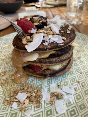 Pancakes with peanut butter, raspberries, and blackberries (plus coconut and granola)  at Peanut's Café in Sainte-maxime