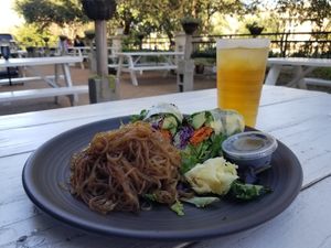 Avocado roll, tahini dressing, sweet potato noodles on the beautiful patio. at Nancy's Sky Garden in Austin