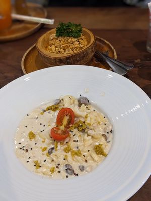 Creamy mushroom pasta and a side of chorizo tofu at Pure Vegan Heaven in Koh Samui