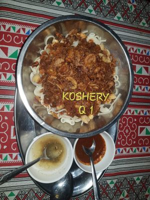 KOSHERY 
( VEGAN Best sillier Dish) 
       Layers of white rice, Macaroni, Spaghetti, black lentils, chickpeas topped with special tomato garlic sauce and fried onions.
 at The Pharaoh's Restaurant in Vientiane