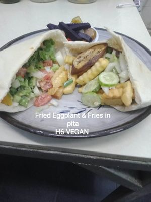 Fried Eggplant &Fries
     Slices of fried eggplant mix with fries, fresh onions, tomato and tahini.
 at The Pharaoh's Restaurant in Vientiane