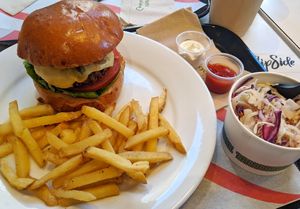 Burger with fries and slaw at Flipside in London