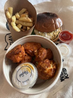 Burger, fries and cauliflower wings, plenty of sauces    at Flipside in London