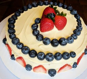 Custom order cake. Vanilla cake with cream cheez frosting filled with berries in the center and top! at The Baked Vegan Bakery in Lake Park