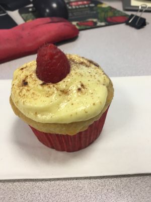 Vanilla cupcake, cream cheese frosting, cinnamon, and a fresh raspberry on top! at The Baked Vegan Bakery in Lake Park