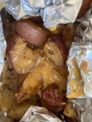 loaded home fries.. no green onions, cheese & bacon bits😁 at Tiki Loco in Dallas