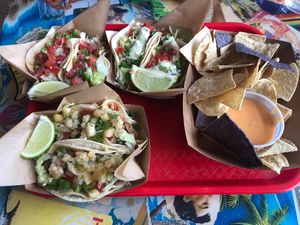 Steak Poke, Chipotle Chicken, ground beef tacos with chips and queso at Tiki Loco in Dallas