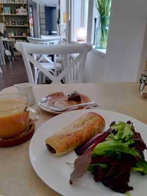 vegan haggis roll, breakfast tea with oat milk, in a corner booth  at Cafe Wynd in Dunfermline