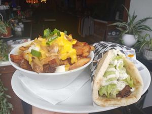 Seitan pita with a really good tzatziki and a side of poutine. at Nooch in Windsor