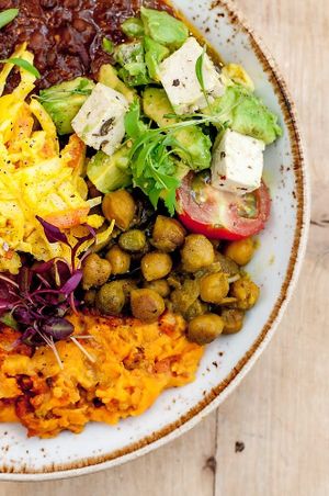 Mixed platter of hot food and avocado salad  at Erpingham House at Cloud Twelve in West London