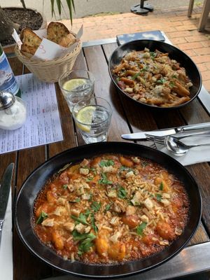 Baked gnocchi in front, baked penne in back. Garlic and herb bread in basket. at Rococo in Hawthorn