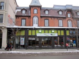 Front of Commensal, now rebranded as Resto Végo. (Also, a random me who had no idea she was going to be in the photo, else she might have turned around and smiled). at Commensal - St Denis in Montreal