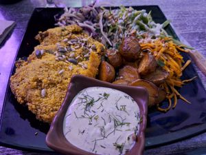 Schnitzel with potatoes, salads and dill sauce at Balance Bowl in Gzira