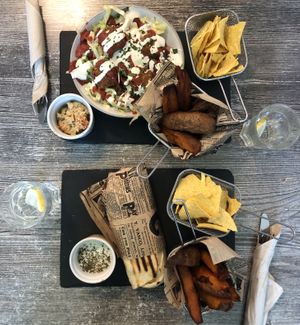 Wrap, falafel salad and sweet potato fries. at Balance Bowl in Gzira