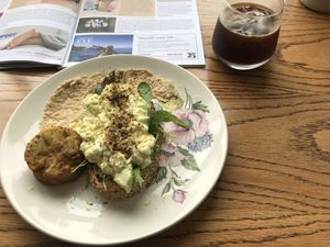 Tofu scramble with potato cake side and iced black coffee  at Moment in Christchurch