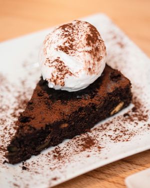 Chocolate avocado brownie with vegan coconut ice cream at Roots & Rolls in Barcelona