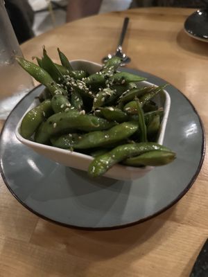 Edamame with delicious sauce!   at Roots & Rolls in Barcelona