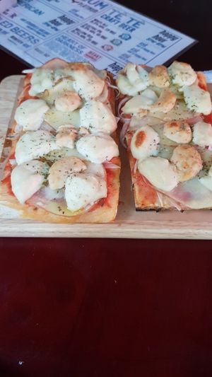 Two slices with cashew cheese, potato, onion, oregano. Added some spicy sauce at Vicolo1 in Ho Chi Minh City