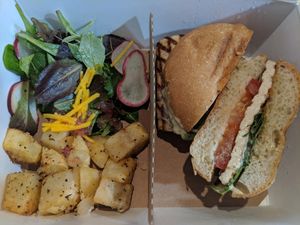 Tofu, basil, tomato, aioli sandwich, herbed potatoes, and a savory salad!  Loved every bite! at Essen Kitchen in Cincinnati