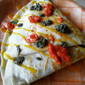 Vegetarian lentil crepe with extra pesto, sweet pepper sauce and mango habanero drizzle👌 at Unity Cafe in Parkersburg
